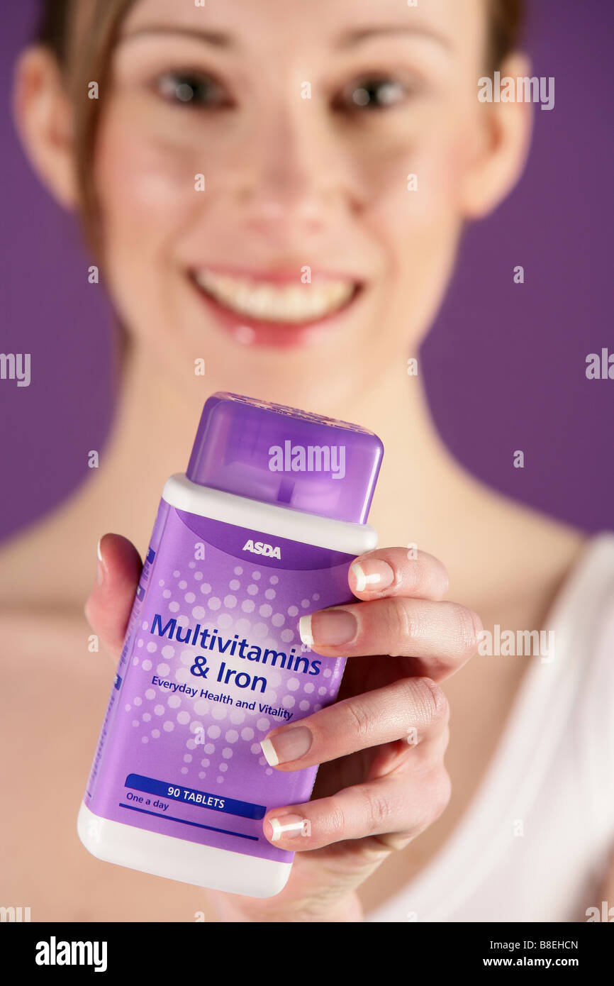Girl holdind a packet of Asda own brand Multivitamins and Iron Stock Photo Alamy