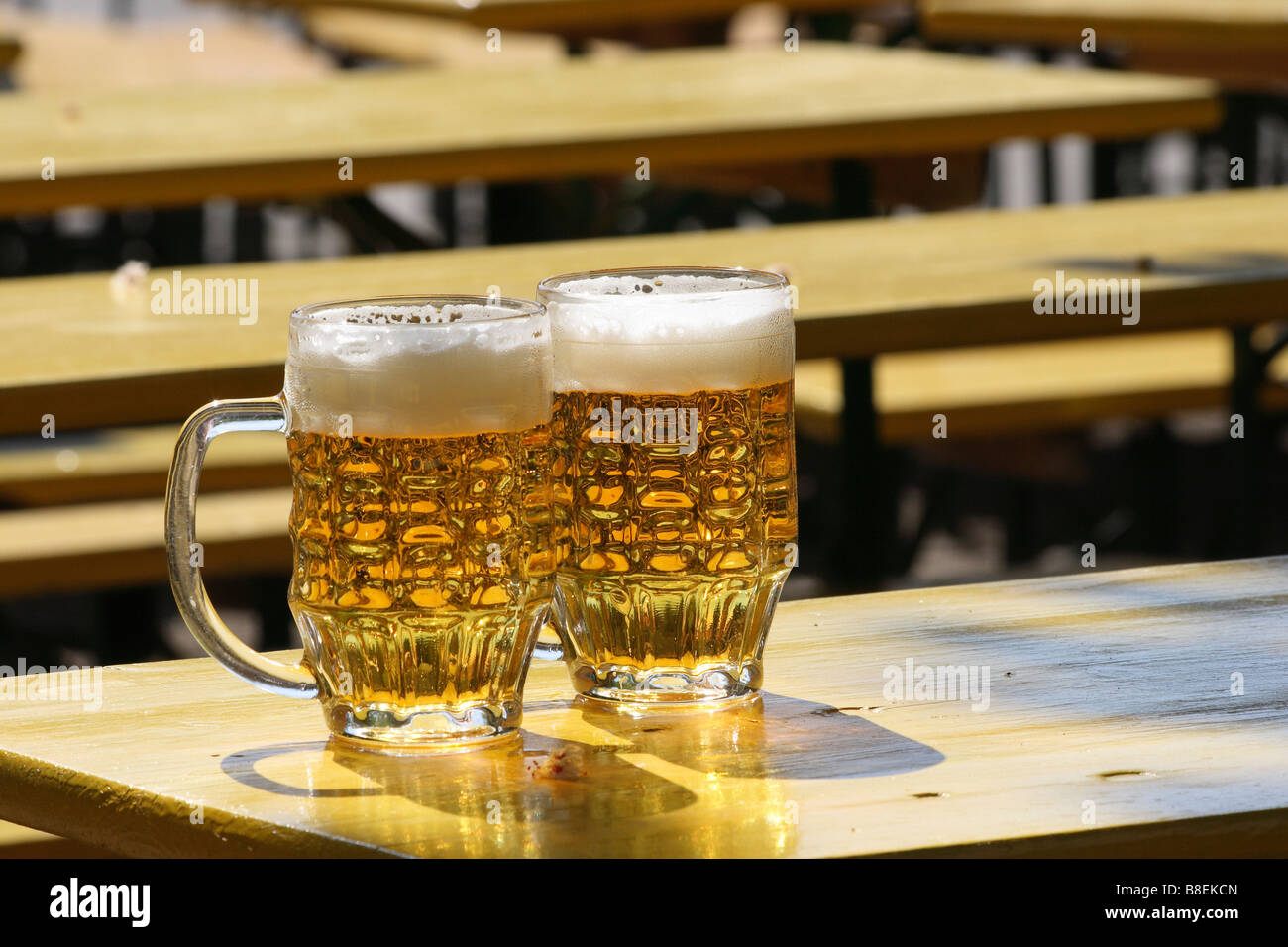 Two beer mugs on a table in a beer garden Stock Photo