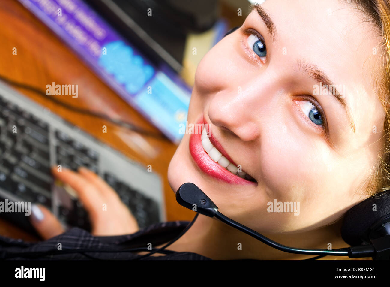 Portrait of beautiful customer service female worker with headphones Stock Photo