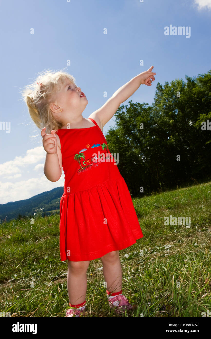 Blond little girl 2 years outdoors Stock Photo