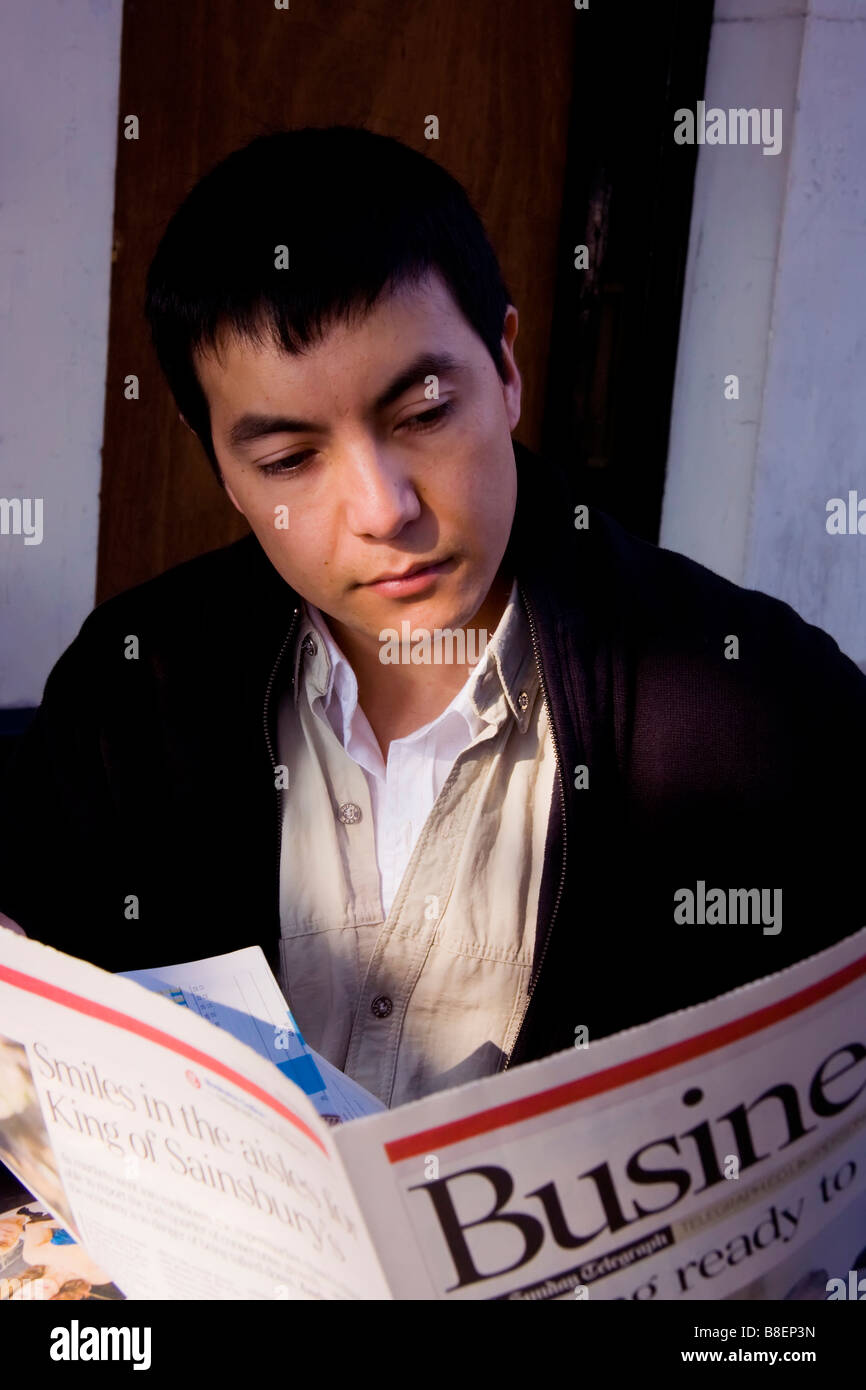 young man reading business newspaper Stock Photo - Alamy