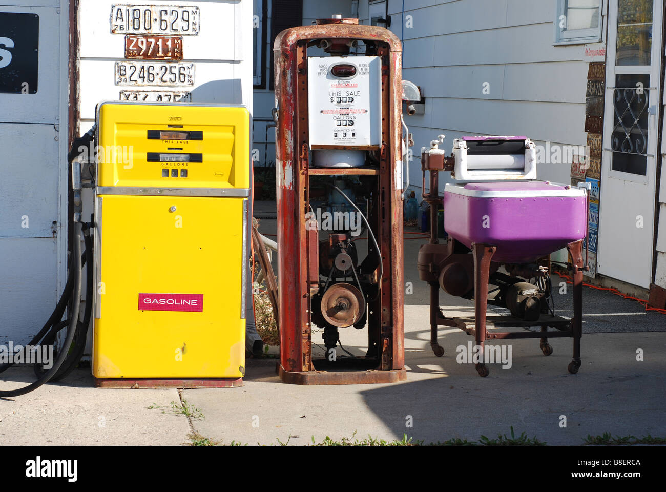 Antique gas pumps and a washer make an unusual still life Stock Photo