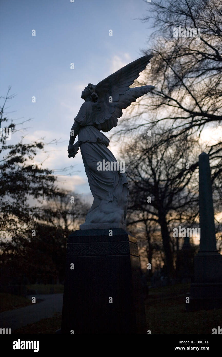A beautiful statue of an angel at a cemetery Stock Photo