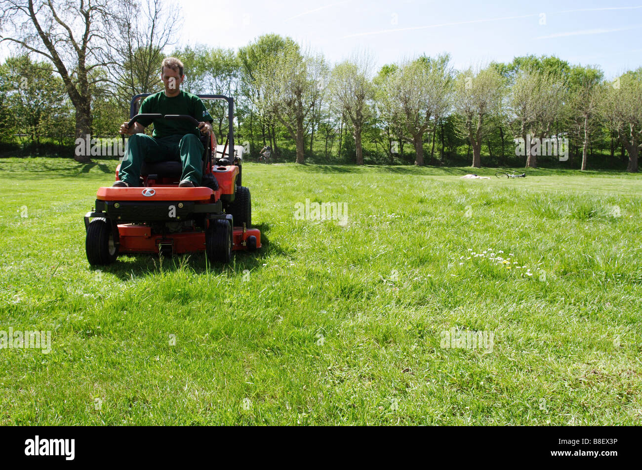 Gardener mowing the lawn with a lawn tractor Stock Photo Alamy