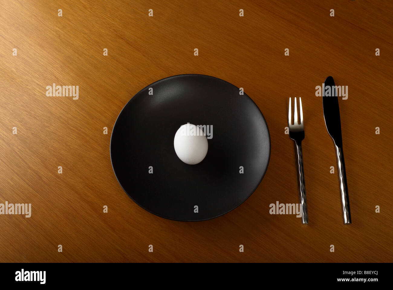 Organic Egg on Black Dinner Plate Stock Photo