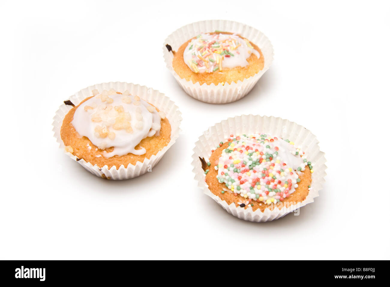 Homemade cup cakes isolated on a white studio background. Stock Photo