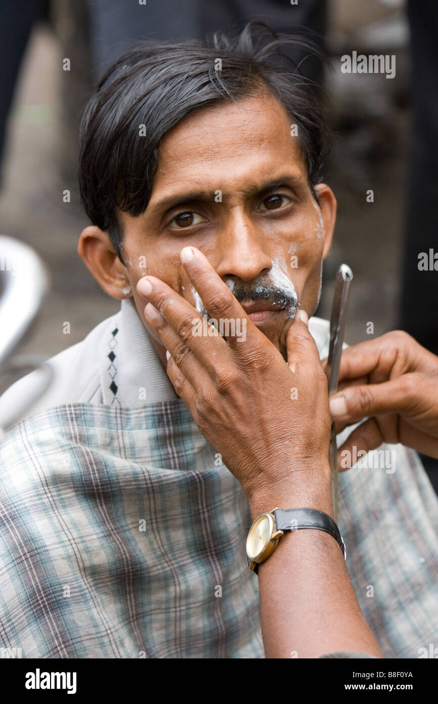 Indian man being shaved in street, Jaipur, India Stock Photo