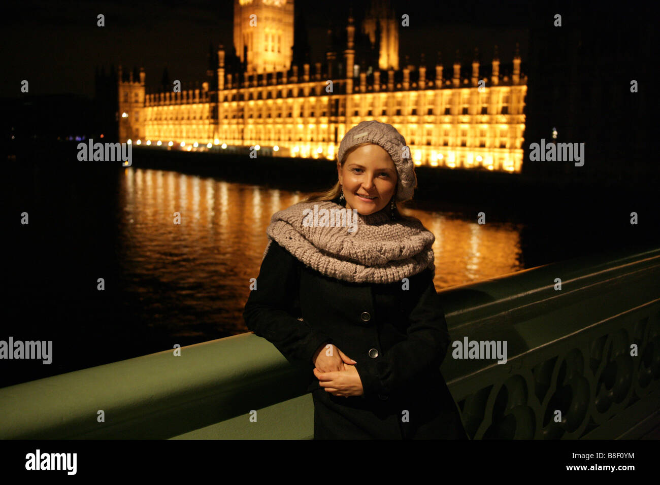 Blonde Ukrainian Girl Wearing Winter Clothes Standing on Westminster Bridge in Front of Westminster Palace at Night Stock Photo