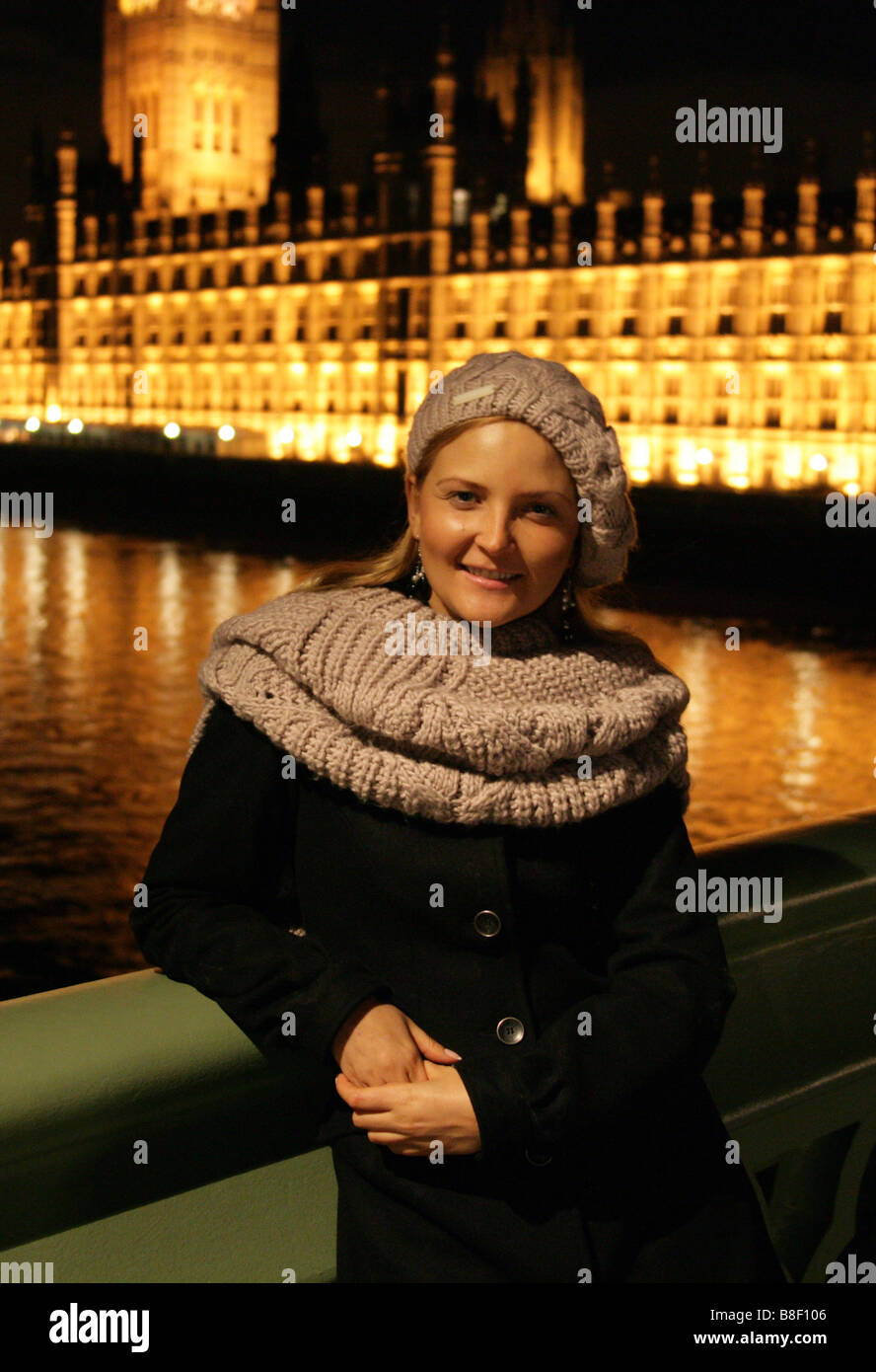 Blonde Ukrainian Girl Wearing Winter Clothes Standing on Westminster Bridge in Front of Westminster Palace at Night Stock Photo