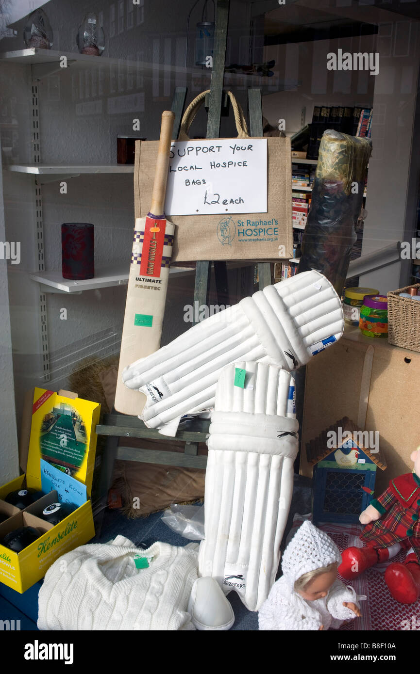 A hospice charity shop window display Stock Photo - Alamy