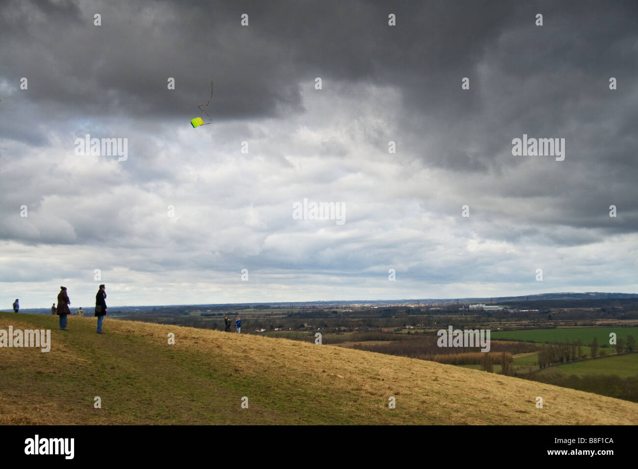 A group of people enjoying the view,and flying a kite. Taken at Whittenham Clumps, Abingdon
