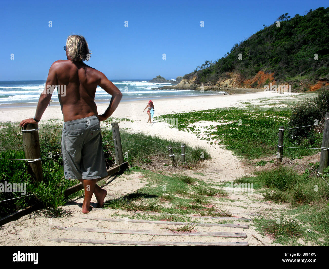 A surfer checks conditions at Broken Head near Byron Bay Australia Stock Photo