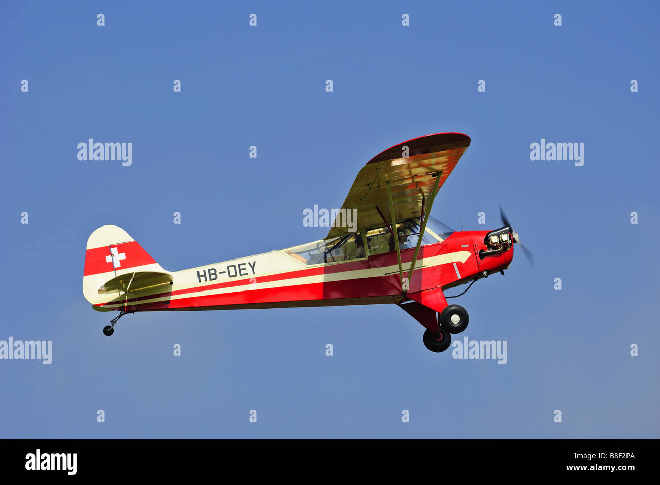 A light aircraft taking off into a clear blue sky. Space for text in the sky. Stock Photo