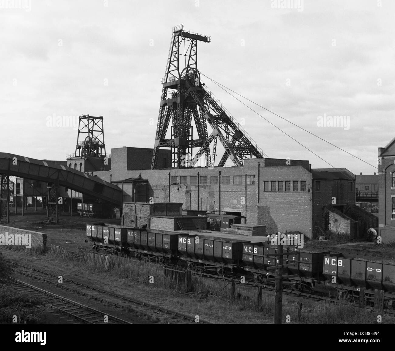 The pithead of Boldon Colliery coal mine with NCB coal trucks in the foreground, north east England, UK Stock Photo