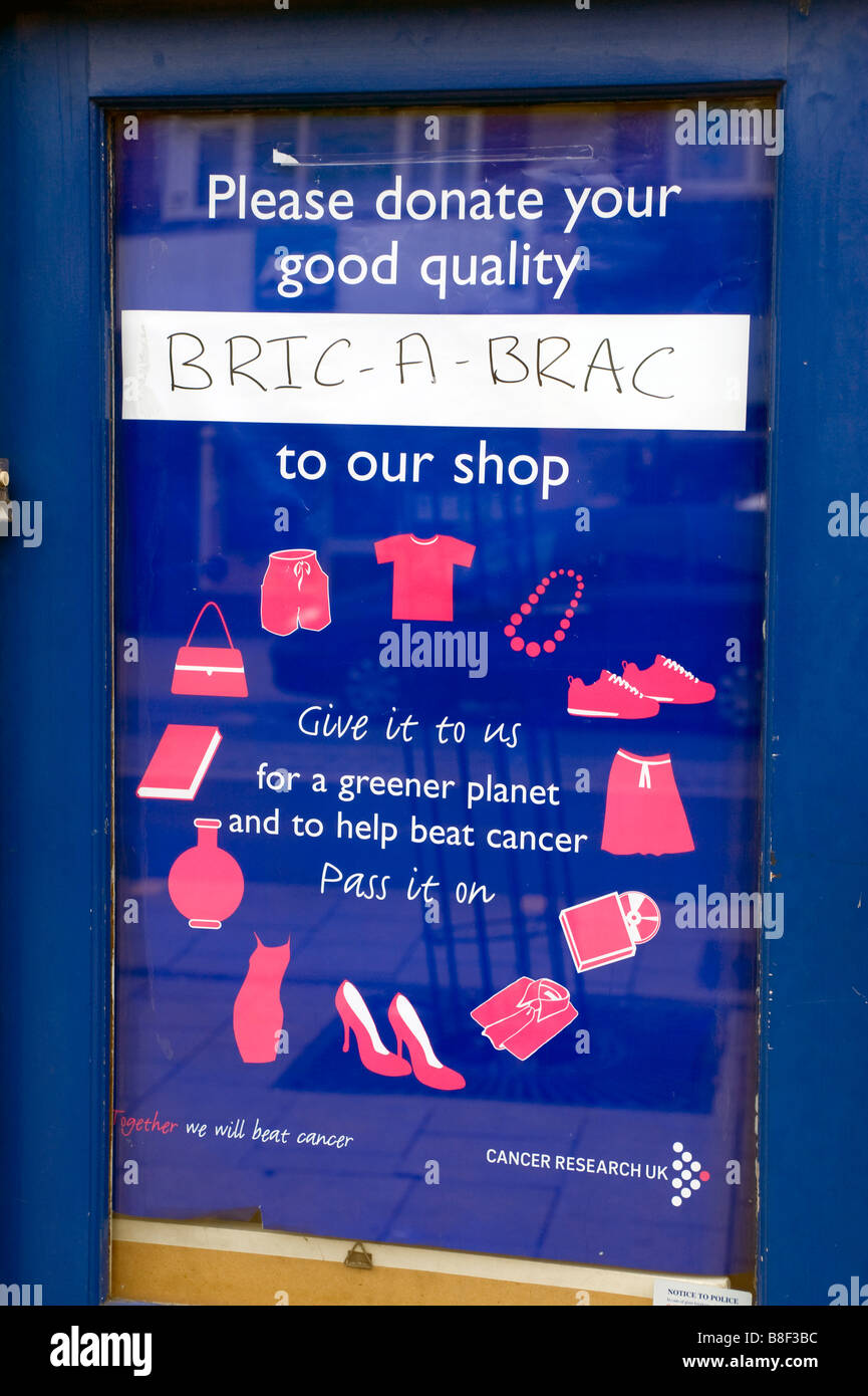 A Cancer Research Charity Shop Door Poster Asking For Donations