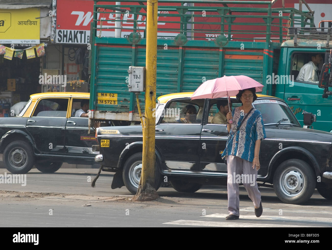 Women crossing road with pink umbrella Stock Photo - Alamy