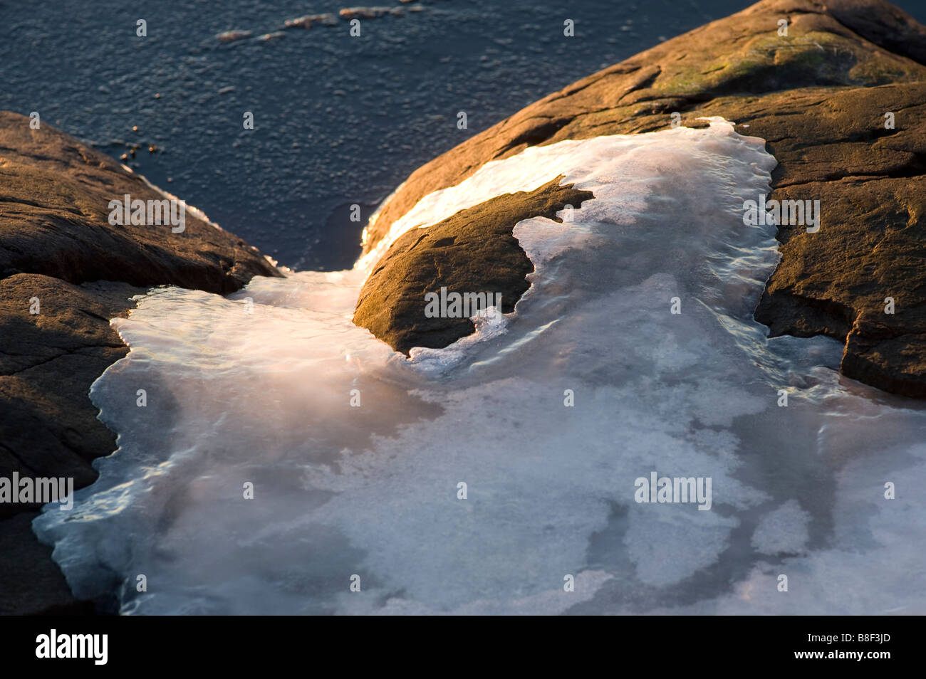 Ice on coastel rocks (as a winter detail in nature), Sweden Stock Photo