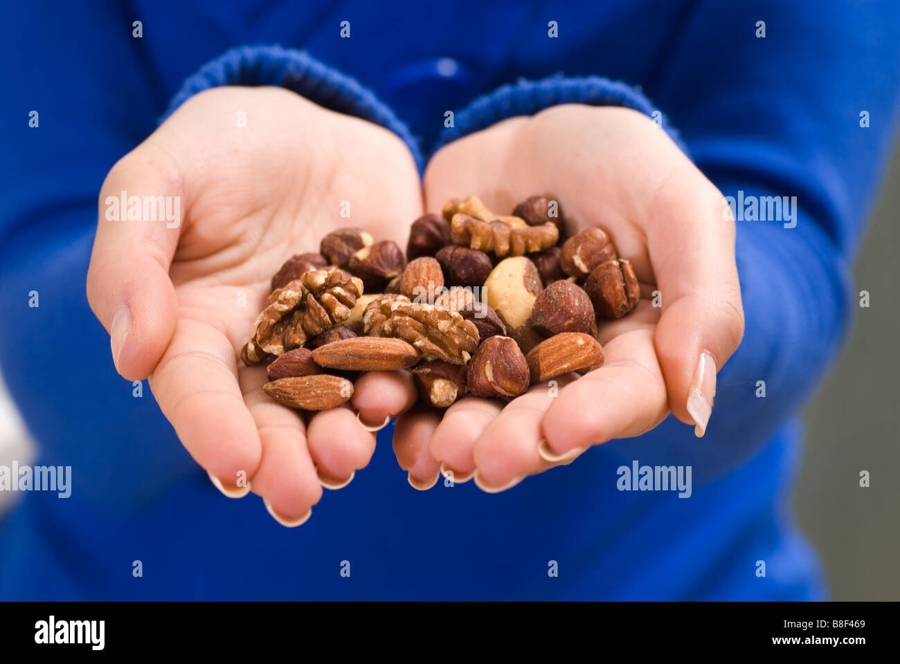 Woman's hand holding nuts Stock Photo