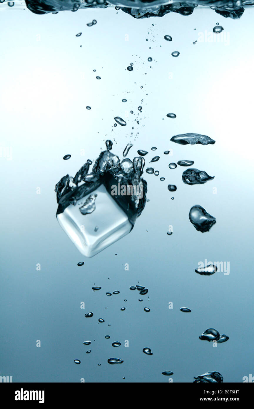 Close up of an ice cube falling into water Stock Photo - Alamy