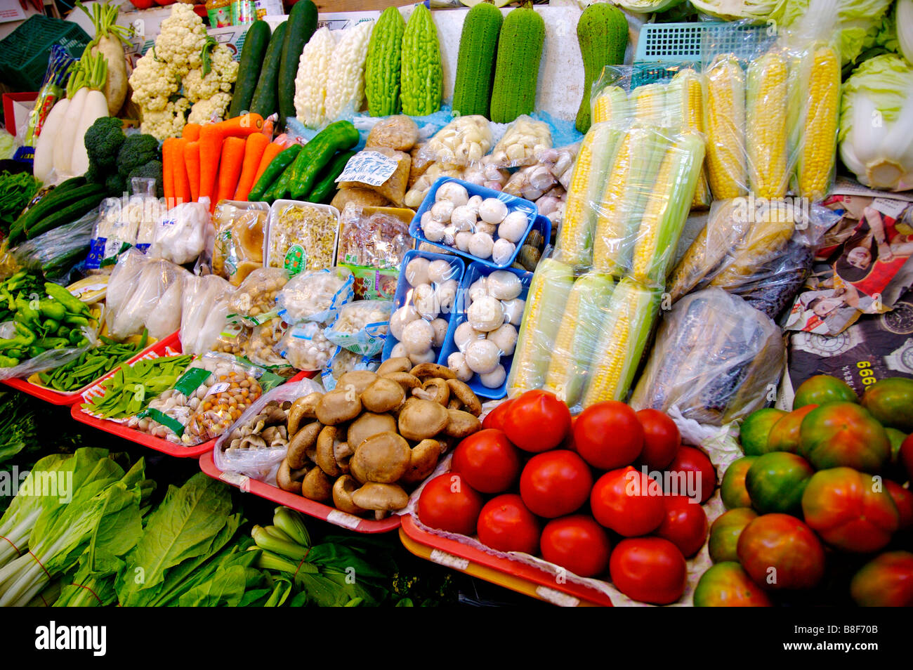 Different vegetables on display at a stall in a market Stock Photo
