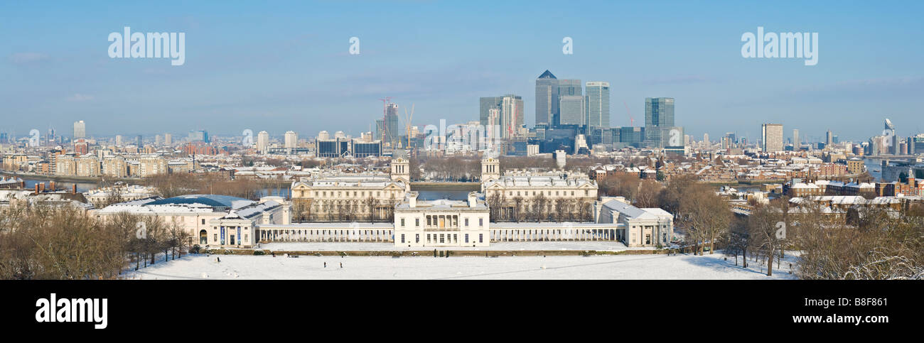 A 3 picture stitch panoramic view from Greenwich Park overlooking Maritime Greenwich and Canary Wharf with snow on the ground. Stock Photo