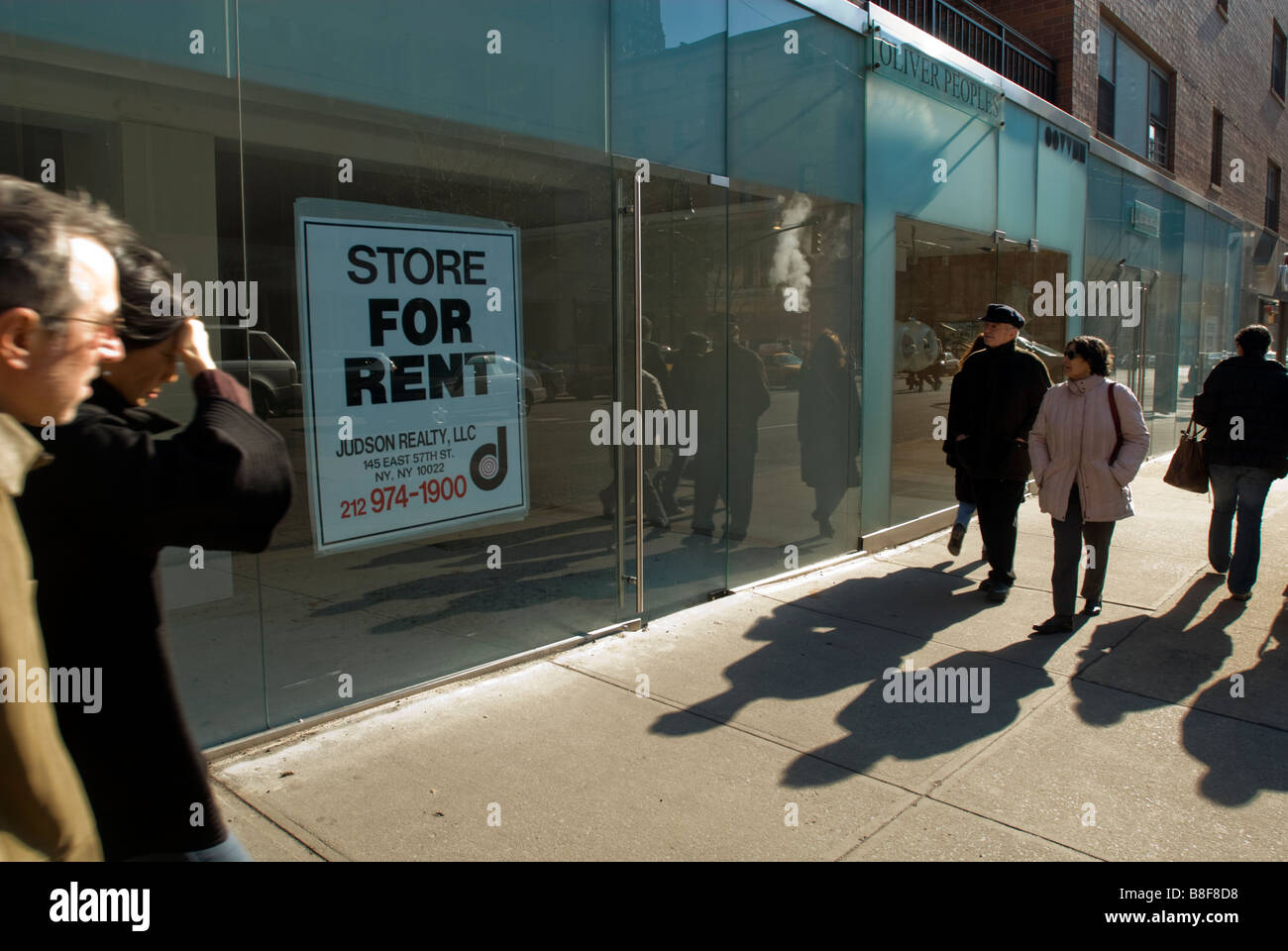 Shoppers pass by a closed store on Madison Avenue in New York on Sunday February 8 2009 Richard B Levine Stock Photo