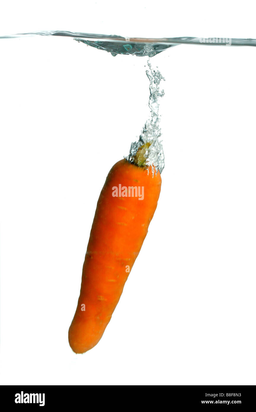 A carrot falling into water Stock Photo Alamy