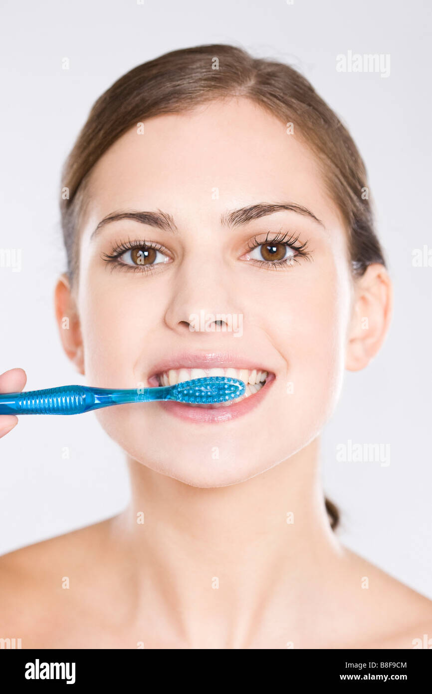 young woman brushing her teeth Stock Photo Alamy