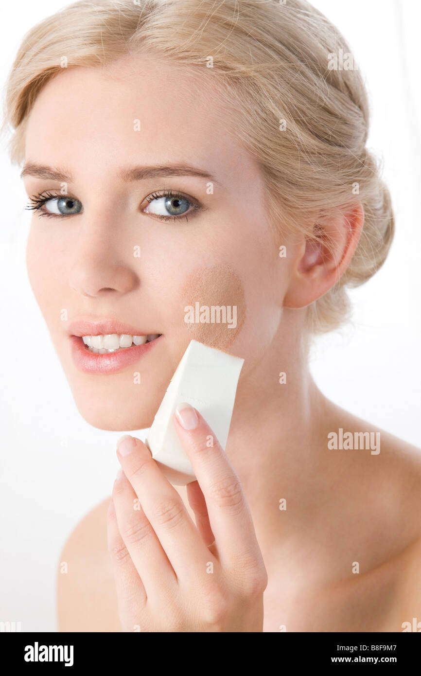 woman applying makeup Stock Photo