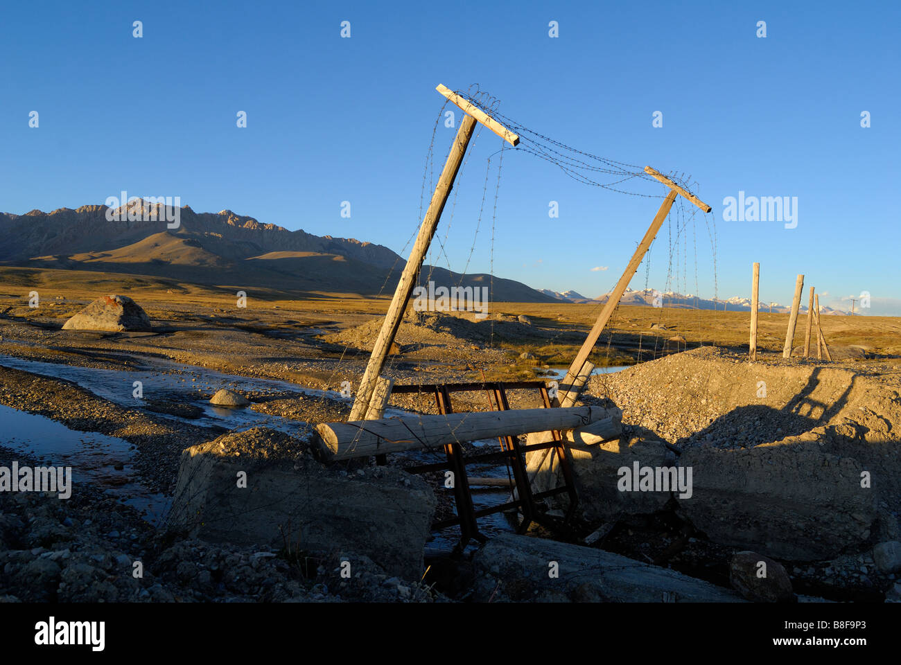 Remainders of the "Iron Curtain" today, old Soviet border between China and Kyrgyzstan Stock