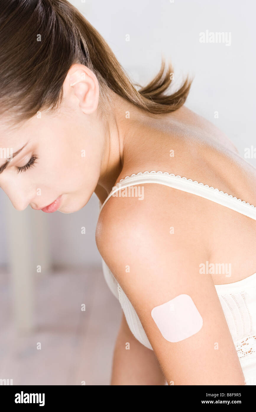 young woman with contraception patch Stock Photo