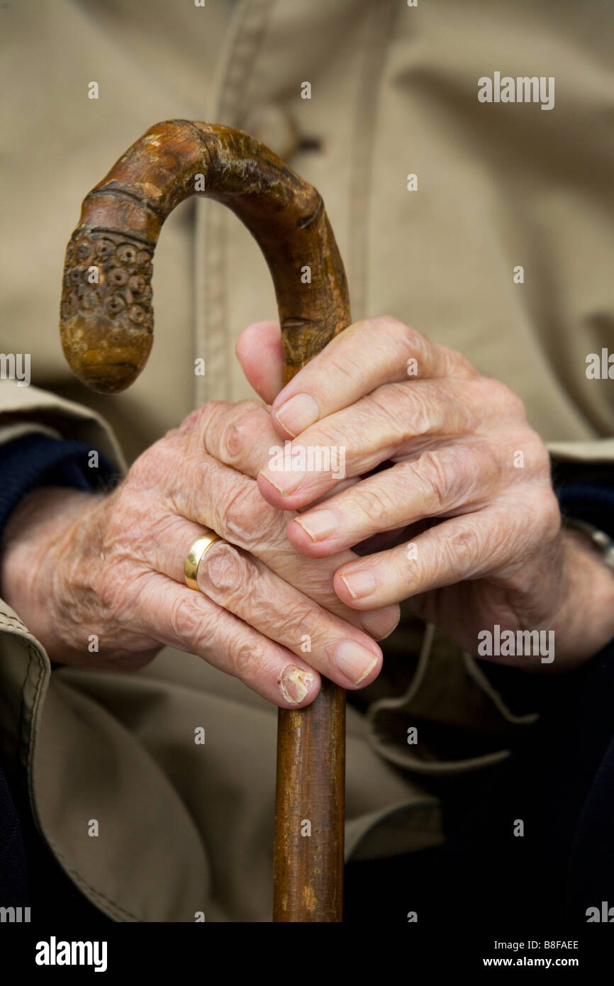 old hands holding walking stick Stock Photo Alamy