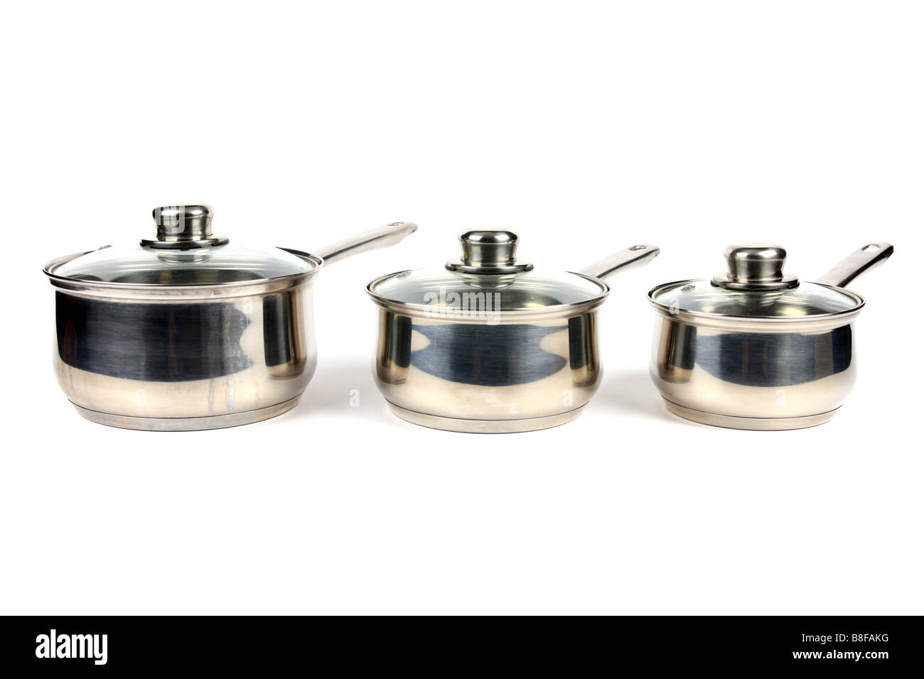 Three Stainless Steel Saucepans with glass lids against a white