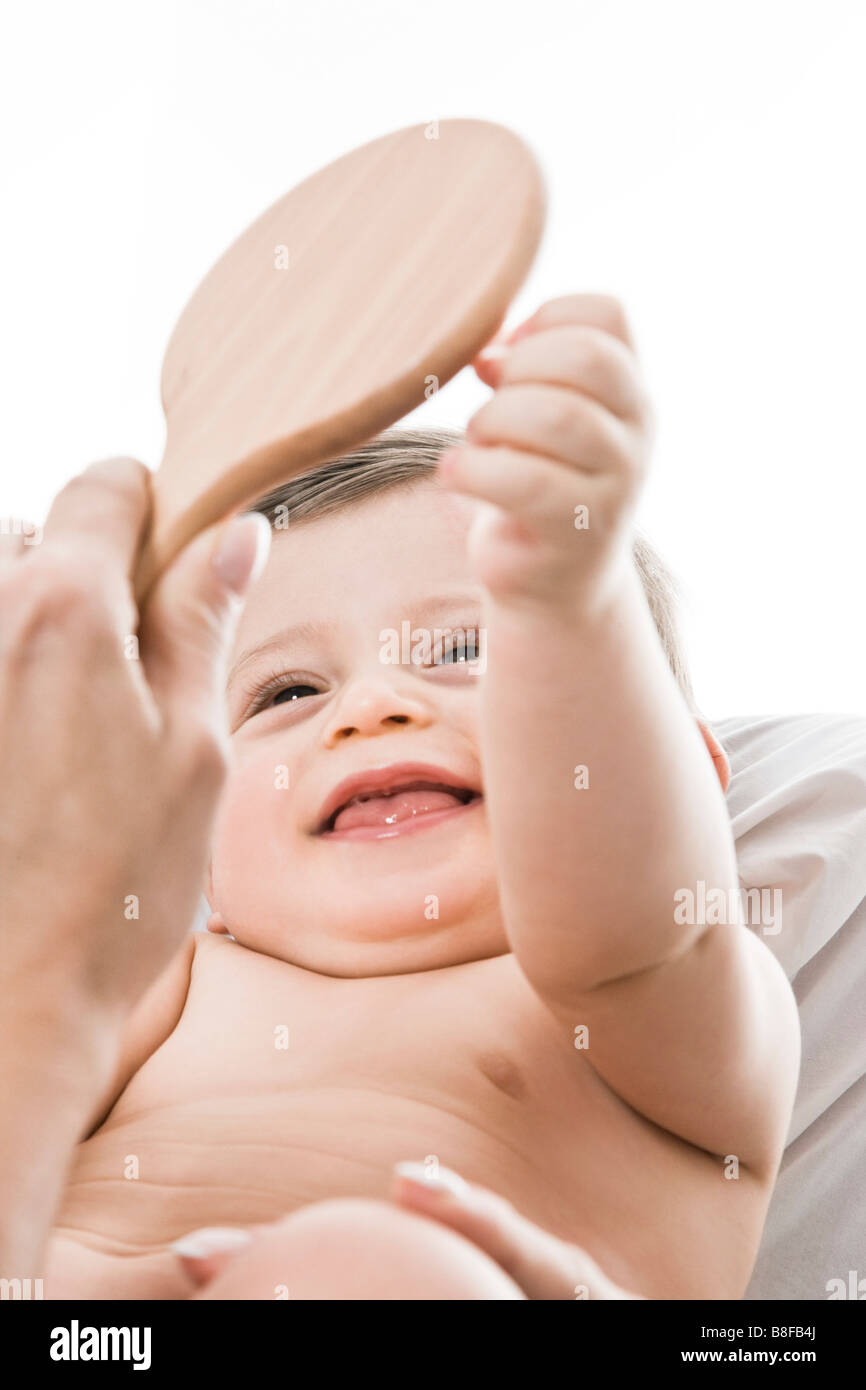 Baby laughing to mirror Stock Photo