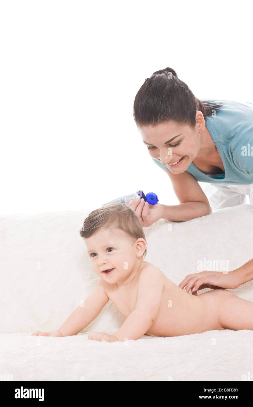 Mother applying cream on baby skin Stock Photo