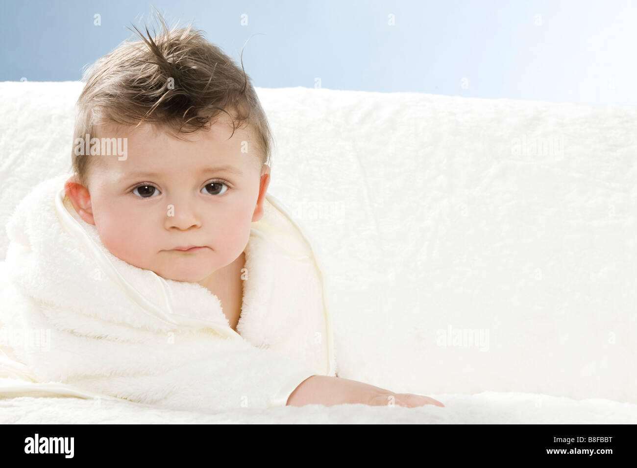 Baby in dressing gown after taking bath Stock Photo