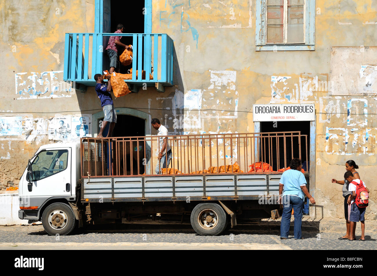 Men unloading a lorry, Sal Rei, Boa Vista Island, Republic of Cape Verde Stock Photo