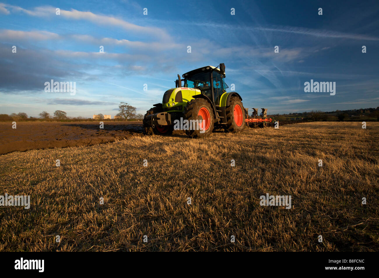 Ploughing Field with a Claas Ares 697 ATZ Tractor Stock Photo