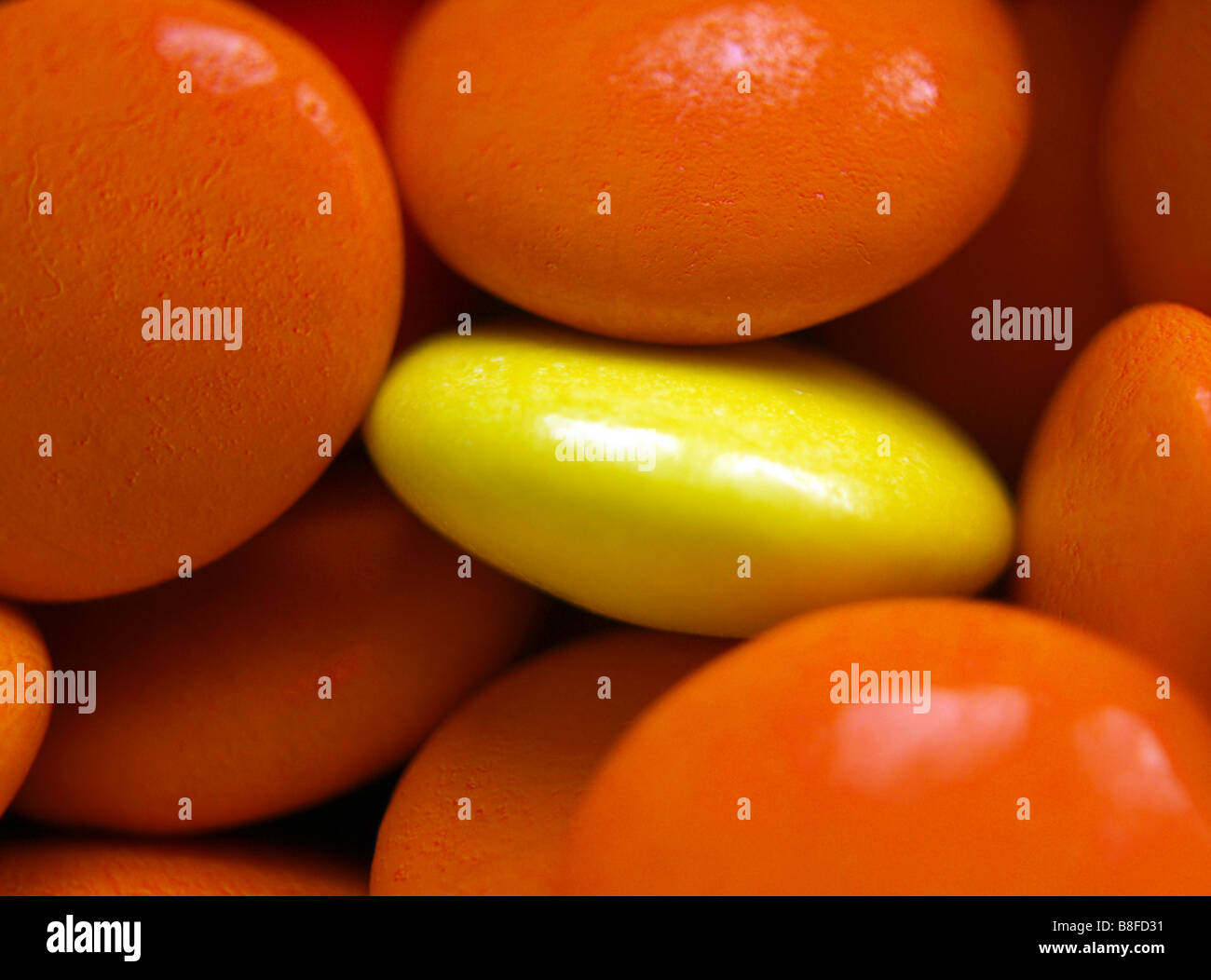 Close up og bright orange and yellow smarties. Stock Photo