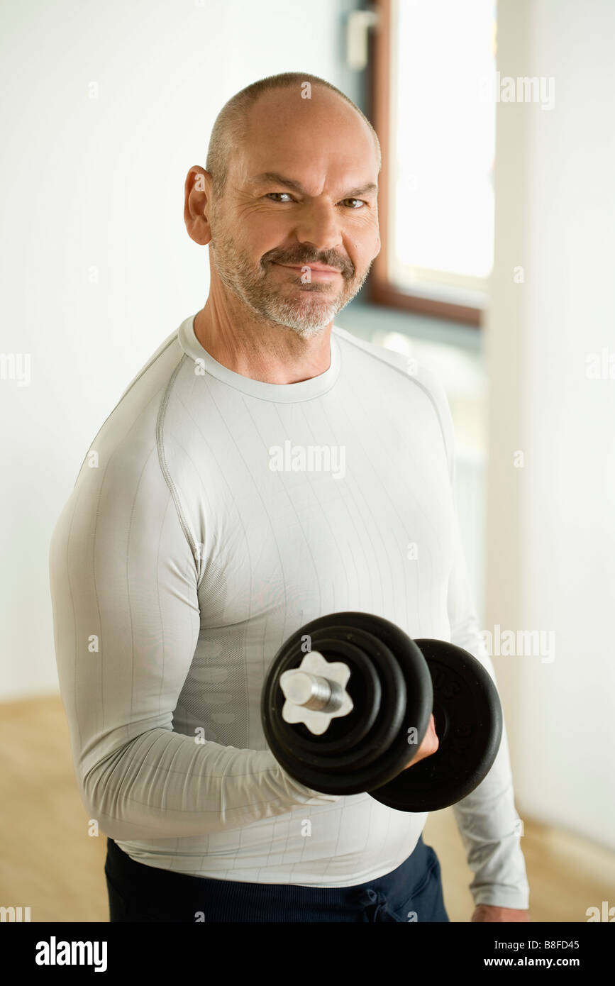 Mature lifting dumb bell, Munich, Bavaria, Germany Stock Photo