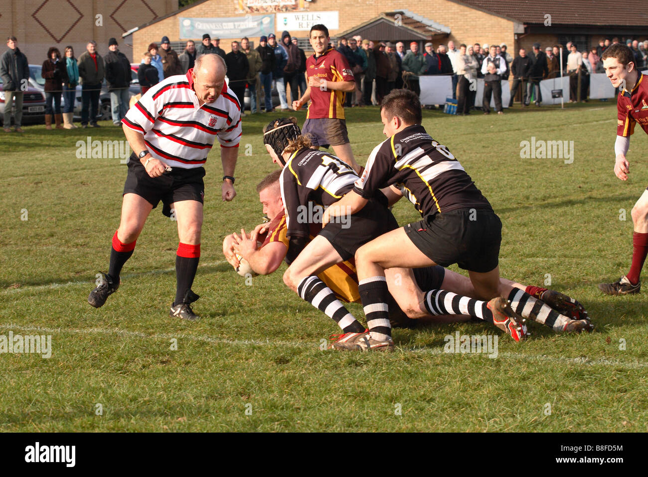 Amateur rugby match game with a try being scored with the ref referee