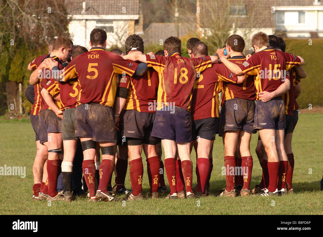 Sport rugby match half time team talk players squad members gather around their coach Stock Photo