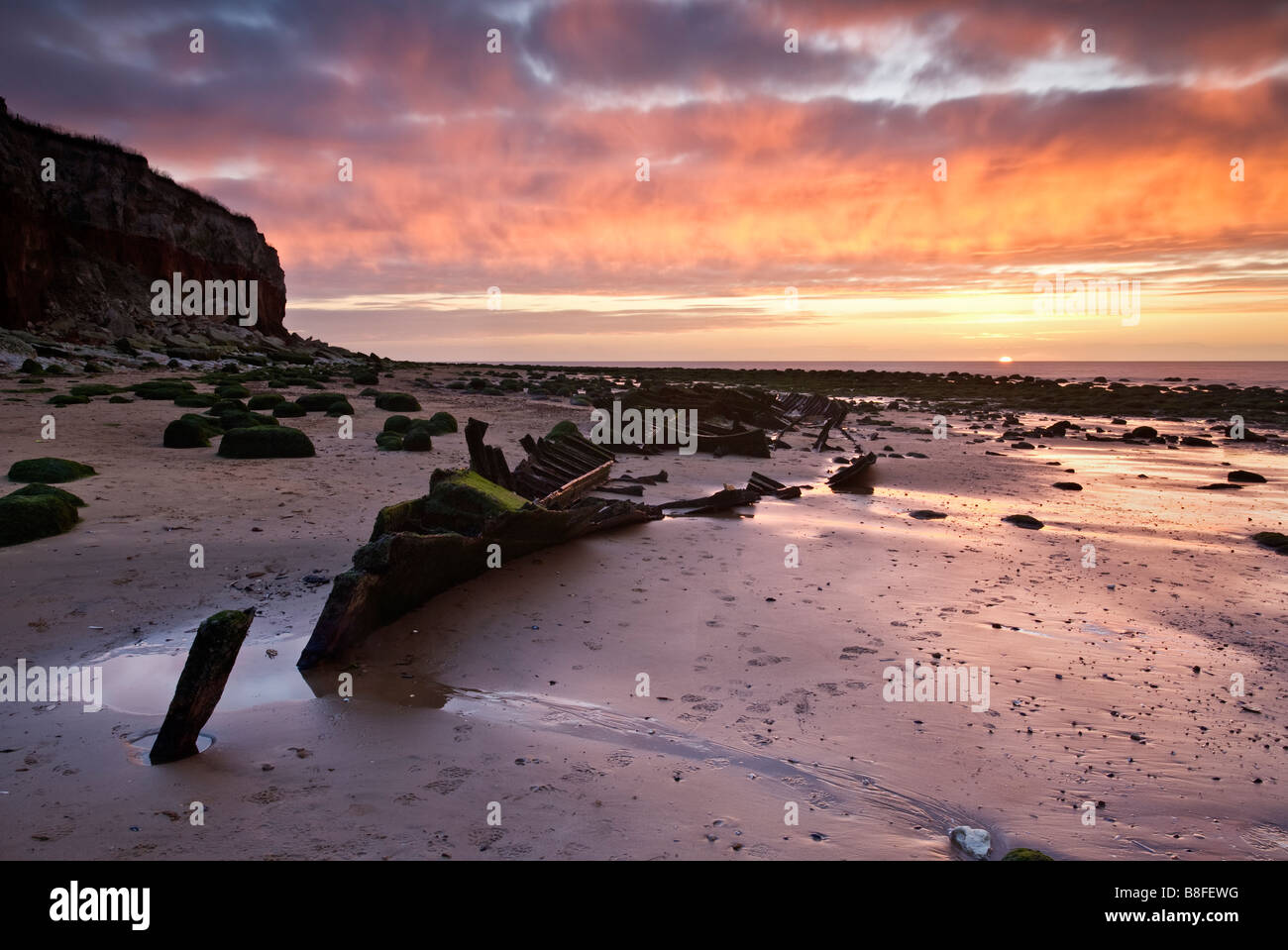 The shipwreck of the hull of the Sheraton built in 1908 and captured at sunset on the North Norfolk coast at Old Hunstanton. Stock Photo