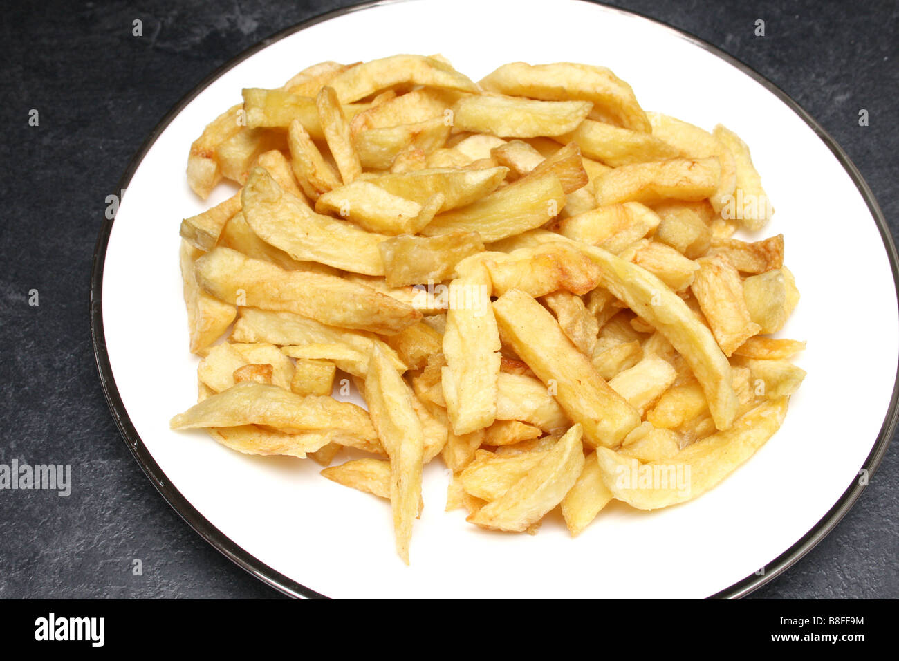 A plate of chip shop chips. Stock Photo