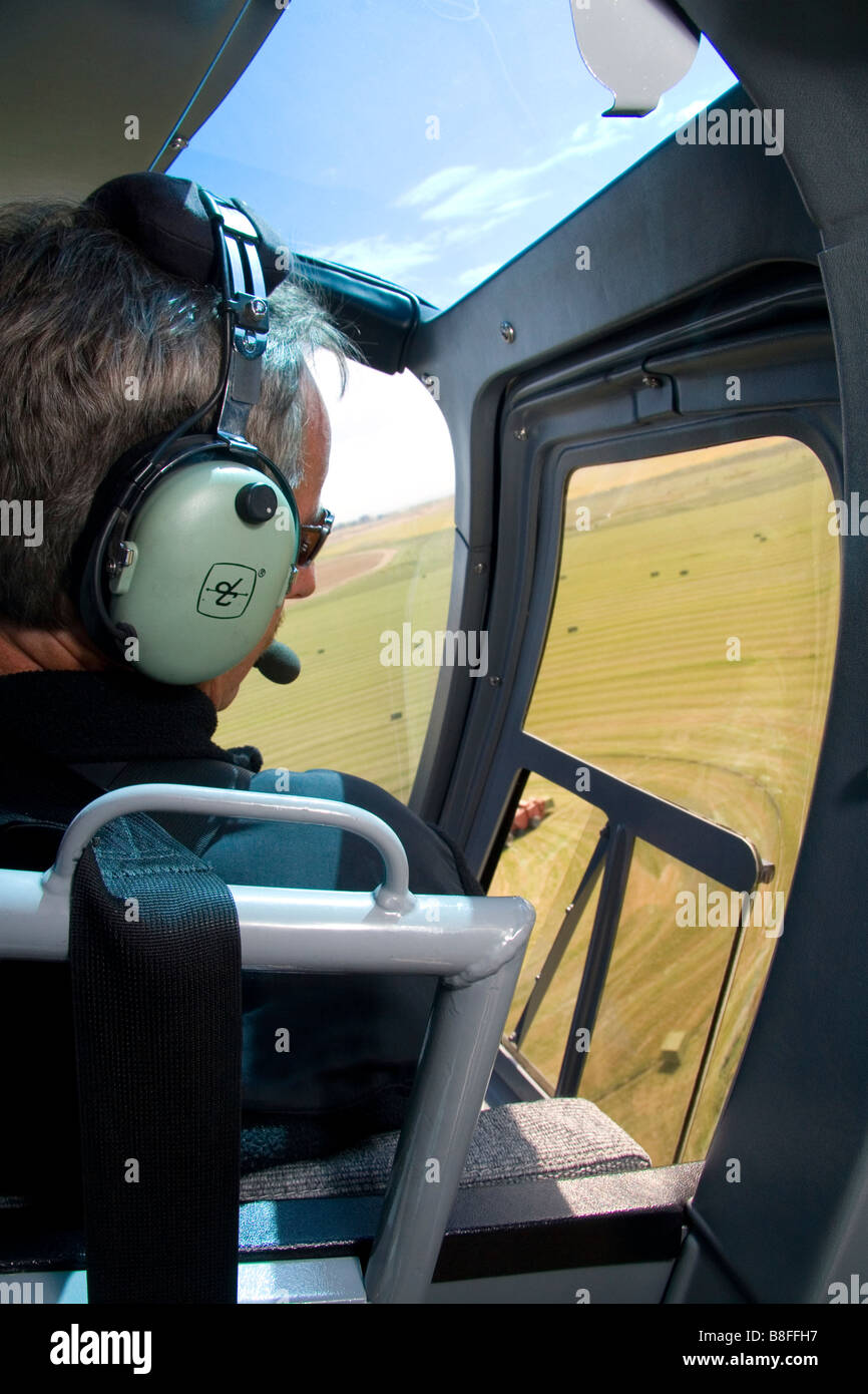 Helicopter pilot viewing alfalfa hay harvest in Jerome Idaho USA Stock Photo