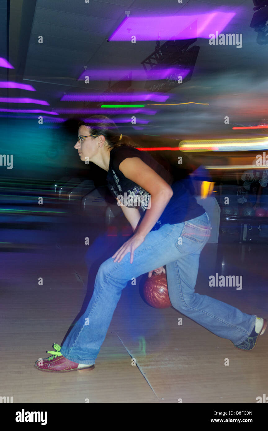 A young woman bowling Stock Photo