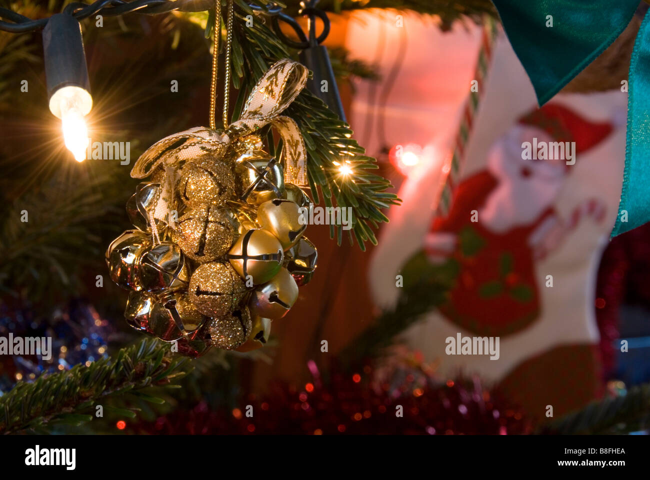 Close up on Golden Bells of a Rattle Decoration Hanging on Christmas Tree Stock Photo