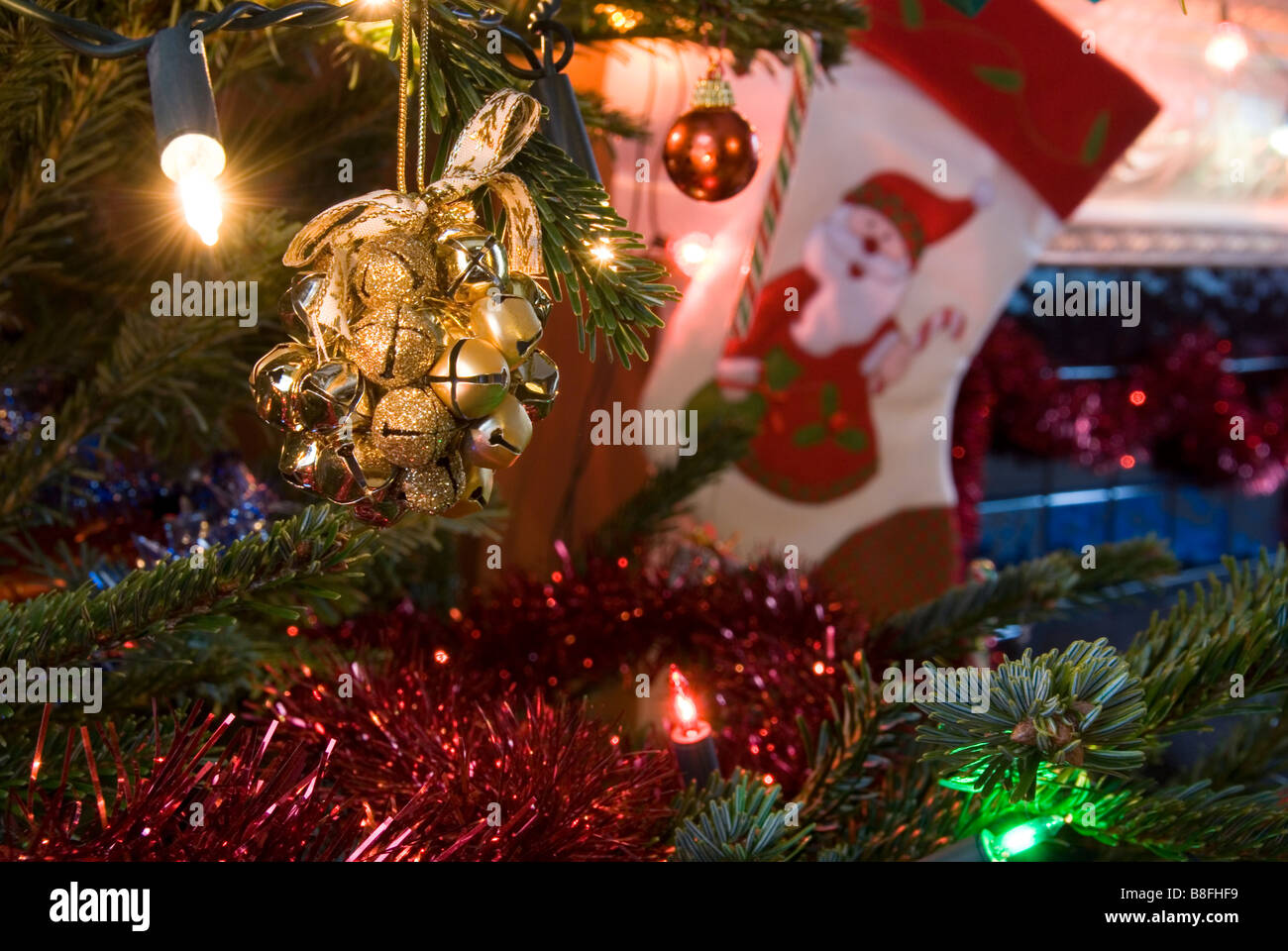 Close up on Golden Bells of a Rattle Decoration Hanging on Christmas Tree Stock Photo