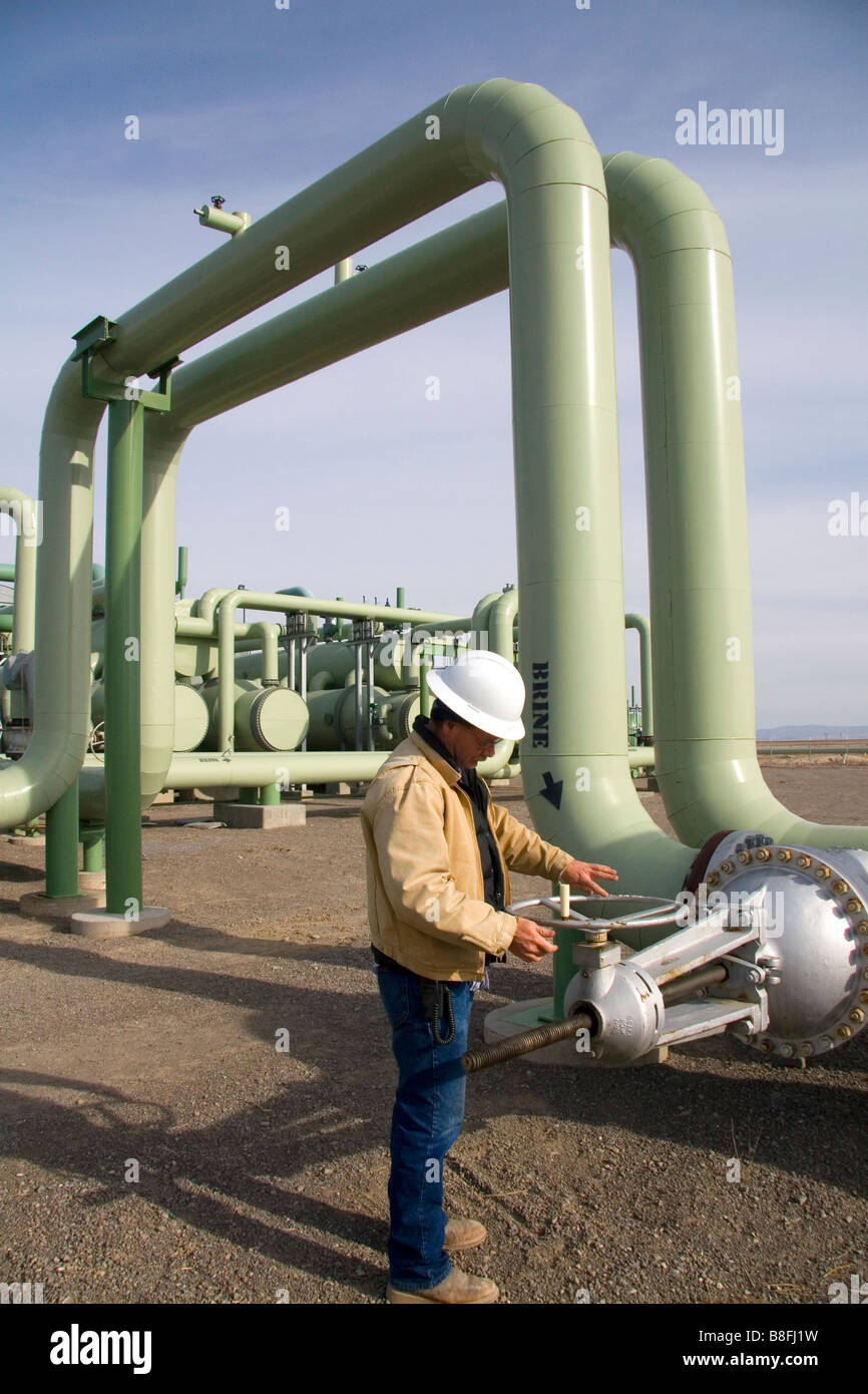 Operator turning a valve at a geothermal power plant in Malta Idaho USA