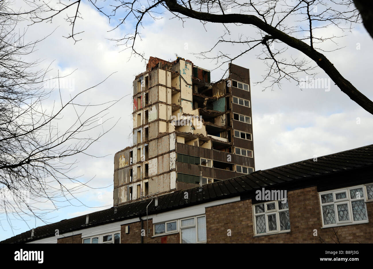 Demolition of 1960's high rise tower of flats in the inner city area of Highgate, Birmingham. Homes below not being demolished. Stock Photo